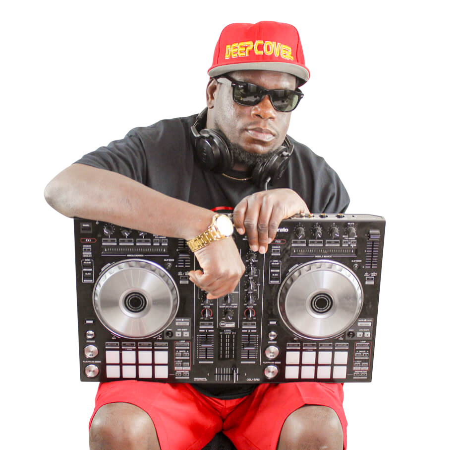 DJ Deep Cover wearing a red Deep Cover cap, seated behind his DJ controller