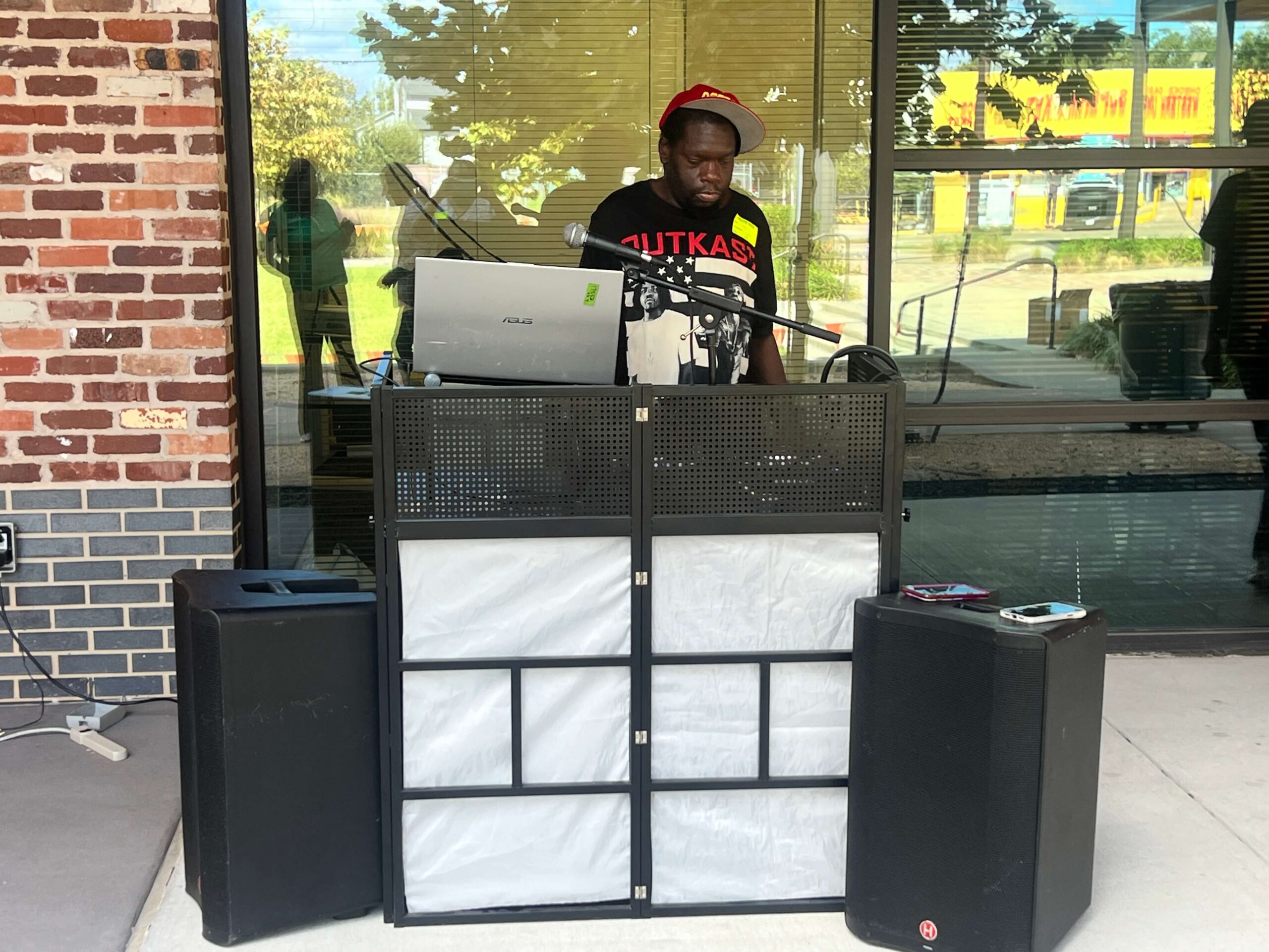 DJ Deep Cover performing at an outdoor community event in Houston